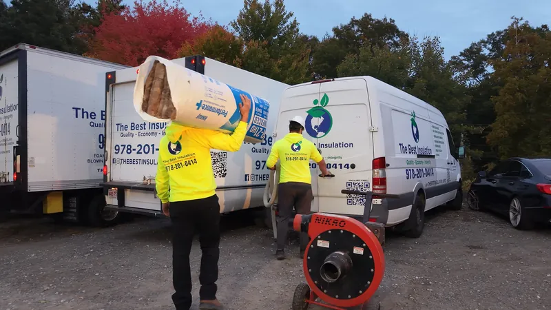 Crew loading insulation into a company truck