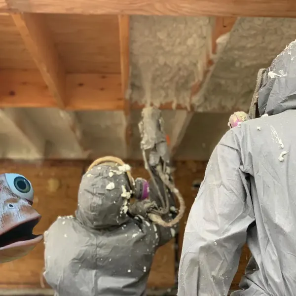 Technician applying spray foam to a ceiling