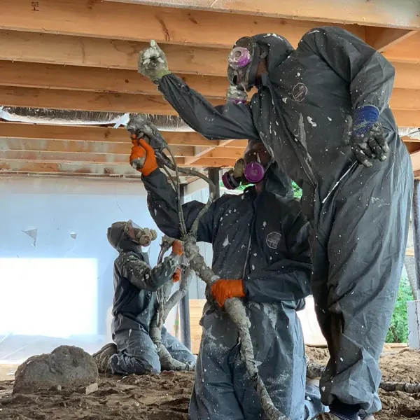 Crew in protective suits after a spray foam job