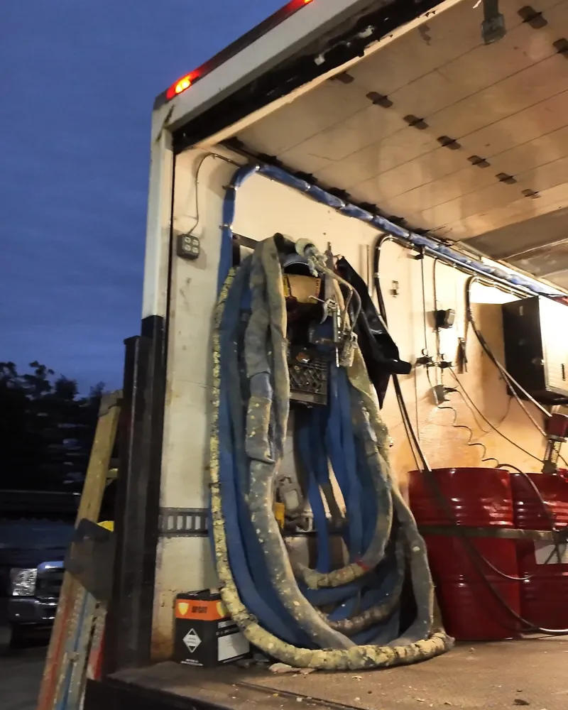 Spray foam rig and hoses inside a company truck